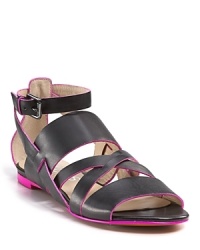 A neon jolt adds vibrant style to KORS Michael Kors' strappy leather sandals. A neon jolt adds vibrant style to KORS Michael Kors' strappy leather sandals.