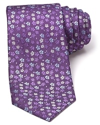 Adorned with a pattern of tonal flowers on a slightly textured background, this luxuriously soft tie freshens up your professional wardrobe with a dash of rich color. Adorned with a pattern of tonal flowers on a slightly textured background, this luxuriously soft tie freshens up your professional wardrobe with a dash of rich color.