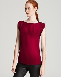 Roll your sleeves up and dig in to chic style with this Alice + Olivia top, constructed in silk and finished with luxe leather trim. Roll your sleeves up and dig in to chic style with this Alice + Olivia top, constructed in silk and finished with luxe leather trim.