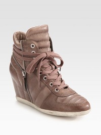 Modern, lace-up leather sneaker has a hidden wedge, side zipper and decorative stitching. Hidden wedge, 3 (75mm)Leather upperSide zipperLeather liningRubber solePadded insoleImported Modern, lace-up leather sneaker has a hidden wedge, side zipper and decorative stitching. Hidden wedge, 3 (75mm)Leather upperSide zipperLeather liningRubber solePadded insoleImported