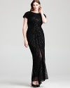 Tadashi Shoji's glamorous, sequin encrusted gown gets seductive with a high front slit in sheer mesh.