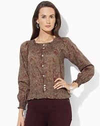 A slightly sheer georgette blouse is rendered with an allover floral pattern, adding feminine allure to any wardrobe. A slightly sheer georgette blouse is rendered with an allover floral pattern, adding feminine allure to any wardrobe.