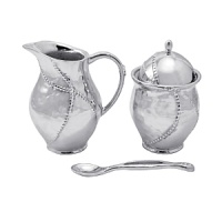Shaped by hand of durable recycled aluminum, this striking creamer and sugar bowl from Mariposa are each detailed with a softly textured finish and beaded edges for a look that's at once organic and refined.