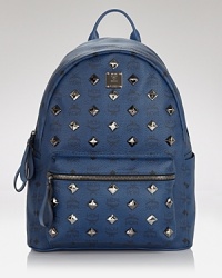 The ever-easy backpack gets a shot of glam in this stunning, studded style from MCM. Crafted of coated canvas and splashed with the label's motif, it's a total throwback. The ever-easy backpack gets a shot of glam in this stunning, studded style from MCM. Crafted of coated canvas and splashed with the label's motif, it's a total throwback.