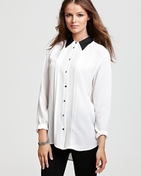 This tuxedo-inspired Equipment blouse takes cocktail dressing in a modern new direction. This tuxedo-inspired Equipment blouse takes cocktail dressing in a modern new direction.