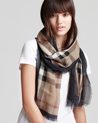 This signature Burberry scarf is the perfect way to tie up every look. This signature Burberry scarf is the perfect way to tie up every look.