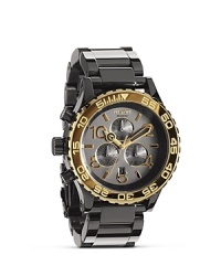 Hard-hitting design meets pace-setting performance on this Nixon watch, which features a plated gunmetal bracelet and advanced Japanese quartz movement. Hard-hitting design meets pace-setting performance on this Nixon watch, which features a plated gunmetal bracelet and advanced Japanese quartz movement.