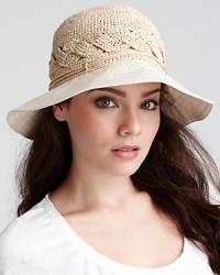 A hand rolled raffia bucket hat with braided detail and a lightweight cotton brim. A hand rolled raffia bucket hat with braided detail and a lightweight cotton brim.