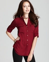 This roll-sleeve Calvin Klein shirt showcases stunning gold-tone accents against a sleek utilitarian silhouette for everyday effortless polish. This roll-sleeve Calvin Klein shirt showcases stunning gold-tone accents against a sleek utilitarian silhouette for everyday effortless polish.