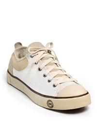 Low lace-up sneakers with cozy shearling lining and an UGG® Australia sole. Low lace-up sneakers with cozy shearling lining and an UGG® Australia sole.