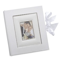 Showcase your favorite photo on the cover of this album, and more inside. A generous ivory bow secures the album, which also makes a thoughtful gift for a wedding or other special occasion. Cover inset is crafted of Lenox white bone china accented with precious platinum. Holds 4 x 6 photo.Height: 1 1/2Width: 8 3/8Length: 9 5/8 Showcase your favorite photo on the cover of this album, and more inside. A generous ivory bow secures the album, which also makes a thoughtful gift for a wedding or other special occasion. Cover inset is crafted of Lenox white bone china accented with precious platinum. Holds 4 x 6 photo.Height: 1 1/2Width: 8 3/8Length: 9 5/8