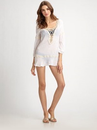 Elegantly ethereal, a cotton gauze coverup with pretty lace details.Deep v-necklineThree-quarter sleevesCottonHand washMade in USA Elegantly ethereal, a cotton gauze coverup with pretty lace details.Deep v-necklineThree-quarter sleevesCottonHand washMade in USA