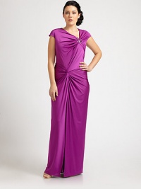 A bejeweled, floor-skimming satin gown that will turn heads this season. The gathered, twist-front bodice is especially flattering for curvy figures.Asymmetrical necklineCap sleevesJewel embellishmentGathered, twist-front bodiceConcealed back zipperAbout 46 from natural waist93% polyester/7% spandexDry cleanImported