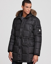 Moncler offers a commanding winter coat that deftly balances form and function with unexpected contrasts and modern craftsmanship. Take the glossy hood, for instance, which sharply offsets the matte shell but is lined with fur for a touch of luxury. Insulated with down for major warmth, and constructed for ease of movement in a trim silhouette, this coat cushions the blow of winter and provides a handsome, top-notch look anywhere you go. Moncler offers a commanding winter coat that deftly balances form and function with unexpected contrasts and modern craftsmanship. Take the glossy hood, for instance, which sharply offsets the matte shell but is lined with fur for a touch of luxury. Insulated with down for major warmth, and constructed for ease of movement in a trim silhouette, this coat cushions the blow of winter and provides a handsome, top-notch look anywhere you go.