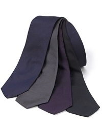Classic skinny silk tie in a solid color. Classic skinny silk tie in a solid color.