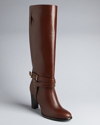 Riding boot style is taken up a notch in these elegant, equestrian-influenced boots. Elongated shafts are grounded with polished ankle wrap details. Riding boot style is taken up a notch in these elegant, equestrian-influenced boots. Elongated shafts are grounded with polished ankle wrap details.