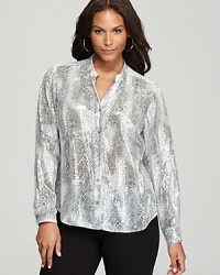 Subtle sequins enliven a snakeskin-print Calvin Klein Plus blouse for a riveting style choice. Play up the tonal palette with sleek sliver accents and embrace untamed glamour.