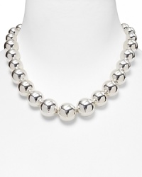 A single strand of metallic beads, graduated from small to large for a sleek, sophisticated silhouette. A single strand of metallic beads, graduated from small to large for a sleek, sophisticated silhouette.