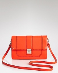 Gleaming hardware shines against the sleek lines of this Milly handbag. A strap hangs from a structured frame, which opens to reveal a lined interior with slots for the evening essentials. Gleaming hardware shines against the sleek lines of this Milly handbag. A strap hangs from a structured frame, which opens to reveal a lined interior with slots for the evening essentials.