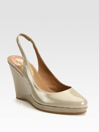 Classically fashionable wardrobe favorite of lustrous patent leather on an elevated wedge and platform. Patent leather wedge, 3¾ (95mm)Patent leather platform, ¾ (20mm)Compares to a 3 heel (75mm)Patent leather upperLeather lining and solePadded insoleImportedOUR FIT MODEL RECOMMENDS ordering one half size up as this style runs small. Classically fashionable wardrobe favorite of lustrous patent leather on an elevated wedge and platform. Patent leather wedge, 3¾ (95mm)Patent leather platform, ¾ (20mm)Compares to a 3 heel (75mm)Patent leather upperLeather lining and solePadded insoleImportedOUR FIT MODEL RECOMMENDS ordering one half size up as this style runs small.