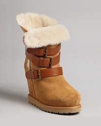 Ash delivers cozy-meets-chic style in these buckled-up wedge booties, perfect for looking cool when temps dip thanks to plush faux shearling. Ash delivers cozy-meets-chic style in these buckled-up wedge booties, perfect for looking cool when temps dip thanks to plush faux shearling.
