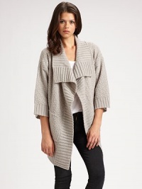 Comfy, textured design with a cropped back hem, shawl collar and bow-tie stitching. Shawl collar Open front Three-quarter sleeves Cropped back hem 85% acrylic/15% nylon Hand wash Imported Comfy, textured design with a cropped back hem, shawl collar and bow-tie stitching. Shawl collar Open front Three-quarter sleeves Cropped back hem 85% acrylic/15% nylon Hand wash Imported