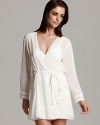 Feel comfortable yet sophisticated in this chiffon cover up wrap with pleated cuffs.