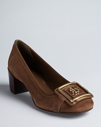 Make room in your closet for iconic design; these retro, Tory Burch pumps feature a classic silhouette punched up with golden logo accents. Make room in your closet for iconic design; these retro, Tory Burch pumps feature a classic silhouette punched up with golden logo accents.