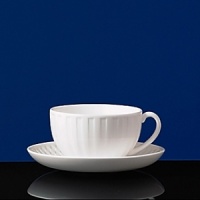 Simple shapes of crisp white are accented with precisely etched lines. Contrasting black matte jasper accessories with glazed interiors are also available. Bone china. Simple shapes of crisp white are accented with precisely etched lines. Contrasting black matte jasper accessories with glazed interiors are also available. Bone china.