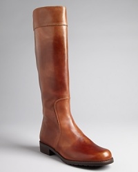 Stuart Weitzman gives these riding boots minimalist design with maximum style impact. Black leather seaming at cuffs finishes off the look. Stuart Weitzman gives these riding boots minimalist design with maximum style impact. Black leather seaming at cuffs finishes off the look.