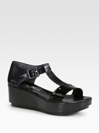 Leather and glossy patent mix together forming this simple t-strap silhouette, heightened by a comfortable platform. Leather-covered wedge, 2½ (65mm)Leather platform, 1½ (40mm)Compares to a 1 heel (25mm)Patent leather and leather upperAdjustable ankle strapLeather lining and solePadded insoleMade in France Leather and glossy patent mix together forming this simple t-strap silhouette, heightened by a comfortable platform. Leather-covered wedge, 2½ (65mm)Leather platform, 1½ (40mm)Compares to a 1 heel (25mm)Patent leather and leather upperAdjustable ankle strapLeather lining and solePadded insoleMade in France