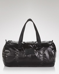 A shiny padded duffel infuses your travel with sleek modern style, a dynamic collaboration between form and function from MARC BY MARC JACOBS. A shiny padded duffel infuses your travel with sleek modern style, a dynamic collaboration between form and function from MARC BY MARC JACOBS.