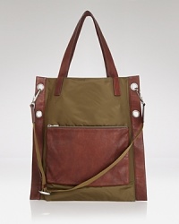 Tote your essentials while following the latest trends when you select this color-block tote from the energetic designer MARC BY MARC JACOBS. Tote your essentials while following the latest trends when you select this color-block tote from the energetic designer MARC BY MARC JACOBS.