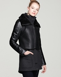 Complexly chic, this Mackage coat layers a leather and shearling vest over a rich wool coat with leather sleeves and a high collar for a look that balances high design with downtown edge. Complexly chic, this Mackage coat layers a leather and shearling vest over a rich wool coat with leather sleeves and a high collar for a look that balances high design with downtown edge.