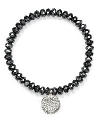 A signature showpiece from Michael Kors, this hematite stone bracelet is detailed with a silver plated charm and stretches for a perfect fit. A signature showpiece from Michael Kors, this hematite stone bracelet is detailed with a silver plated charm and stretches for a perfect fit.