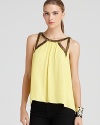 Chic cutout details and beading embellish this silky-soft BCBGMAXAZRIA top with festive flair.