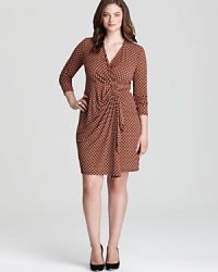 Embrace classic femininity with a retro-inspired MICHAEL Michael Kors Plus wrap dress--extra chic with polished pumps and a statement bag. Embrace classic femininity with a retro-inspired MICHAEL Michael Kors Plus wrap dress--extra chic with polished pumps and a statement bag.