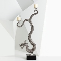 Natori's hand-cast dragon candelabra adds high drama and Eastern influence to your home's interior, and the hand-applied antiquing gives it artifact appeal. Natori's hand-cast dragon candelabra adds high drama and Eastern influence to your home's interior, and the hand-applied antiquing gives it artifact appeal.