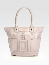 A fantastic blend of lightweight nylon and luxurious leather in a functional carryall.Double leather top handles, 6½ dropTop zip closureTwo outside zip pocketsTwo outside open pocketsRemovable leather luggage tagOne inside zip pocketTwo inside open pocketsFully lined11¾W X 9½H X 3½DImported A fantastic blend of lightweight nylon and luxurious leather in a functional carryall.Double leather top handles, 6½ dropTop zip closureTwo outside zip pocketsTwo outside open pocketsRemovable leather luggage tagOne inside zip pocketTwo inside open pocketsFully lined11¾W X 9½H X 3½DImported