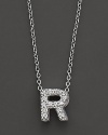 From the Tiny Treasures collection, a diamond R necklace. With signature ruby accent. Designed by Roberto Coin.