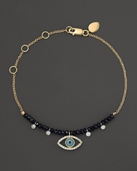 Diamonds and turquoise form a dazzling evil eye on a 14K yellow gold chain. By Meira T.