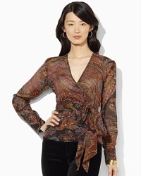 A flowing silk blouse is crafted in a flattering wrap silhouette for breezy, feminine appeal. A flowing silk blouse is crafted in a flattering wrap silhouette for breezy, feminine appeal.