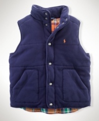 A classic channel-quilted vest is updated with plaid lining for a pop of color to a seasonal staple. A classic channel-quilted vest is updated with plaid lining for a pop of color to a seasonal staple.