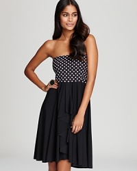 Go dotty for this fun-and-flirty Gottex coverup design-with the coordinating swimwear or solids, it's a little black (and white) dress for the beach.