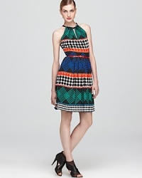 Trina Turk masters the global inspiration of the runways with this eclectic-print dress, finished with a narrow belt for polish. Trina Turk masters the global inspiration of the runways with this eclectic-print dress, finished with a narrow belt for polish.