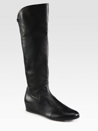 Tall seasonal staple crafted of buttery leather on a small hidden wedge. Hidden wedge, 1¾ (45mm)Shaft, 15½Leg circumference, 12Leather upperPartial side zipLeather lining and solePadded insoleMade in SpainOUR FIT MODEL RECOMMENDS ordering one half size up as this style runs small. Tall seasonal staple crafted of buttery leather on a small hidden wedge. Hidden wedge, 1¾ (45mm)Shaft, 15½Leg circumference, 12Leather upperPartial side zipLeather lining and solePadded insoleMade in SpainOUR FIT MODEL RECOMMENDS ordering one half size up as this style runs small.