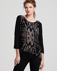 A tribal, burnout pattern lends exotic charm to this slouchy Rebecca Taylor top with chic dolman sleeves. A tribal, burnout pattern lends exotic charm to this slouchy Rebecca Taylor top with chic dolman sleeves.