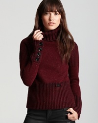 Classic prep meets punk attitude as oversized ribbed trim and bullish button cuffs inject an essential Burberry Brit turtleneck with modern edge. Classic prep meets punk attitude as oversized ribbed trim and bullish button cuffs inject an essential Burberry Brit turtleneck with modern edge.