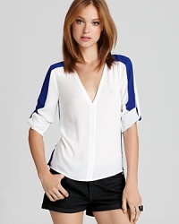 Introduce the color-block trend into your wardrobe with this BCBGMAXAZRIA top, accented with a pop of contrast color. Introduce the color-block trend into your wardrobe with this BCBGMAXAZRIA top, accented with a pop of contrast color.