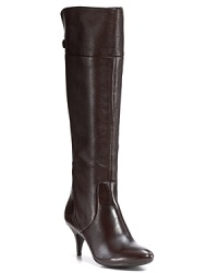 Sleek, seductive leather boots feature a slim heel and updated '70s styling. By Calvin Klein. Sleek, seductive leather boots feature a slim heel and updated '70s styling. By Calvin Klein.
